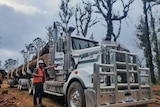 Jarrod Hoskin in front of logging truck