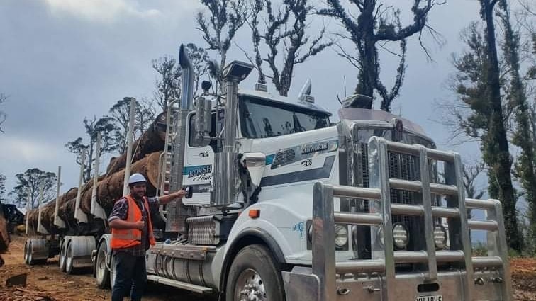 Jarrod Hoskin in front of logging truck