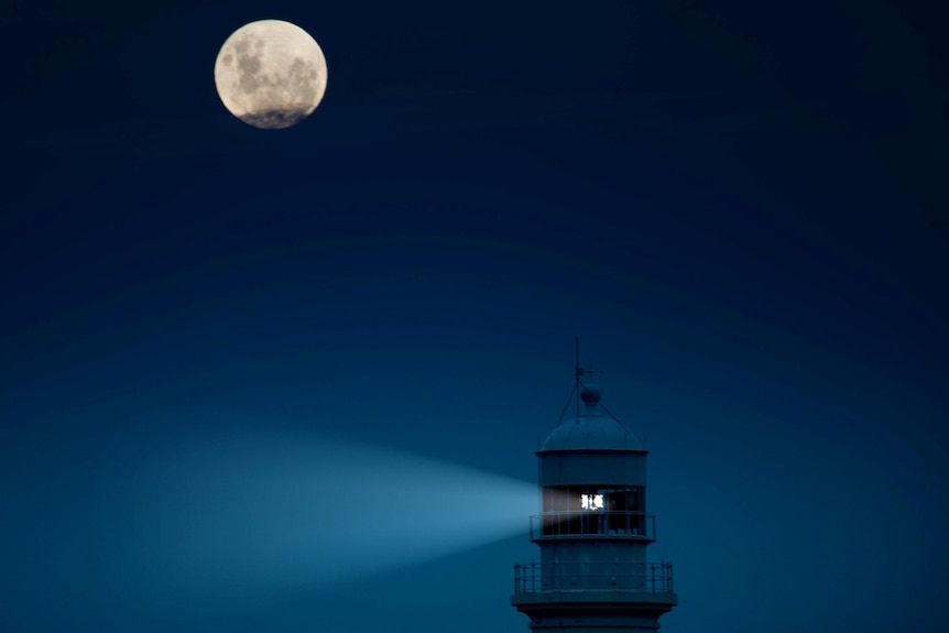 Lighthouse at night with moon
