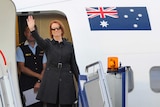 Prime Minister Julia Gillard boards a plane at Fairbairn Airport in Canberra.