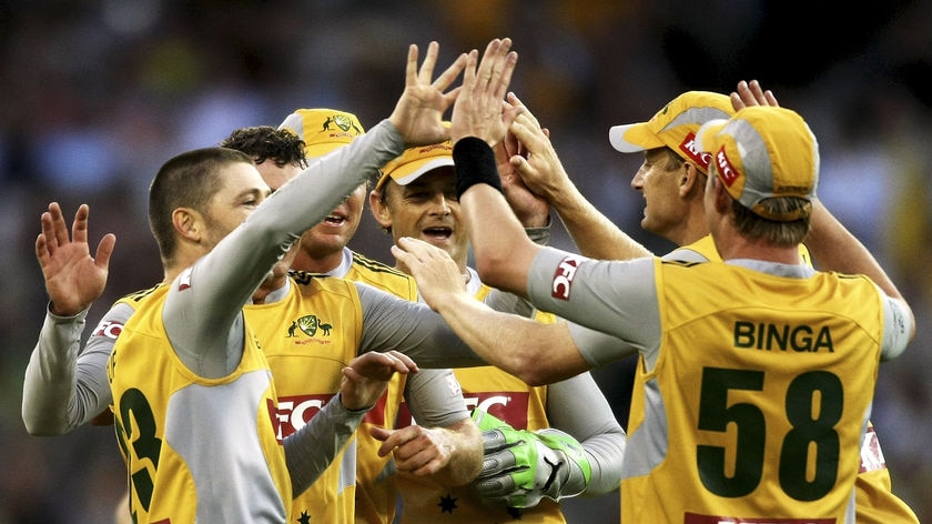 Thrashing... Michael Clarke (R) celebrates a wicket with team-mates.