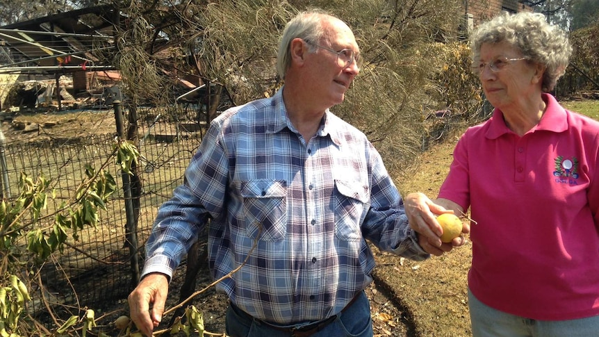 Residents in the backyard of their saved home