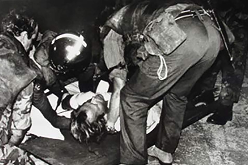 An injured Sebastian Rich being stretchered away in Lebanon