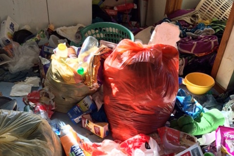 Rubbish strewn around a kitchen in a house in Burnie, Tasmania