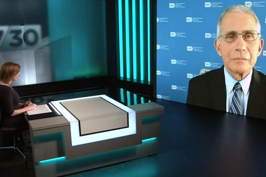 Leigh Sales sits in 730 studio addressing a large screen with a man's face on it.