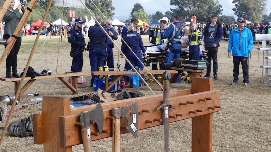 Paramedics surround a man on a stretcher.