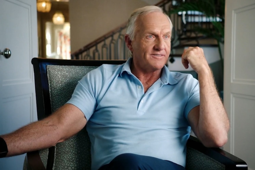 Greg Norman is speaking while sitting in a chair in his home