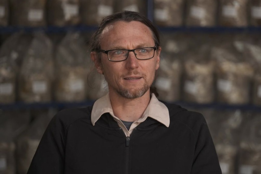 A picture of mushroom grower John Ford seated looking at the camera