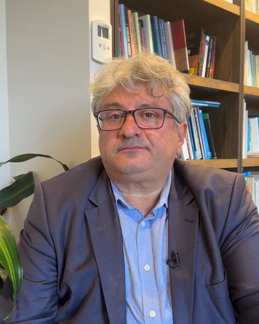 Deakin University's chair of Islamic studies, Ihsan Yilmaz, wears a suit and glasses.