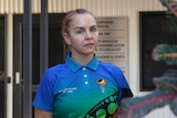 A woman in a colourful shirt looking at the camera