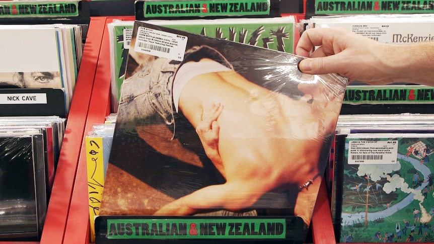 A hand reaches for a record in a section labelled Australian & New Zealand.