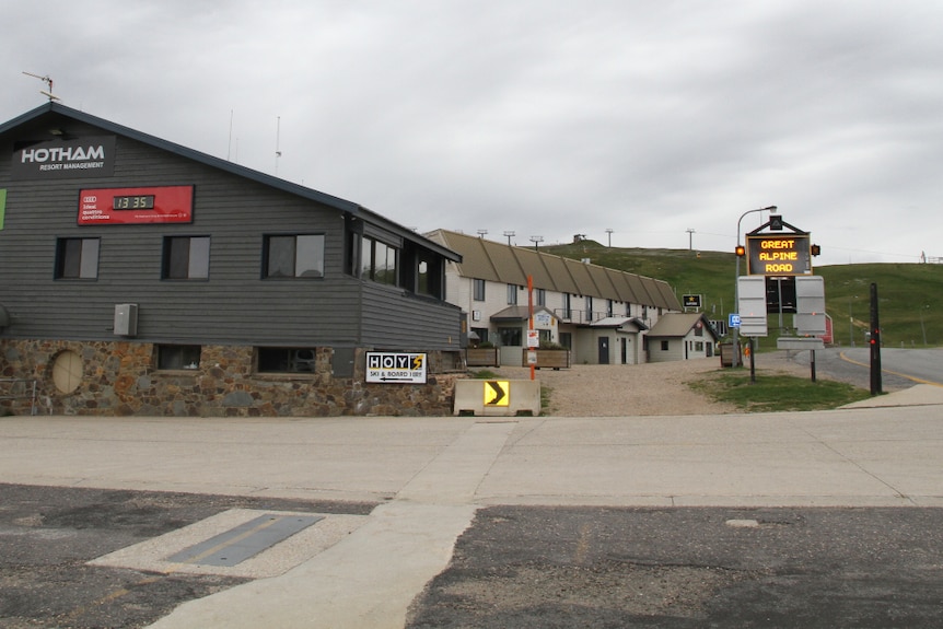 Deserted Mount Hotham street and businesses with a grey clouds in the background