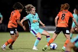 Glory's Alana Jancevski takes on the Roar defenders during an A-League Women's match
