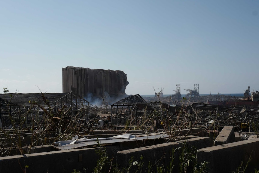 Destroyed grain silos sit amid rubble at a Beirut dock