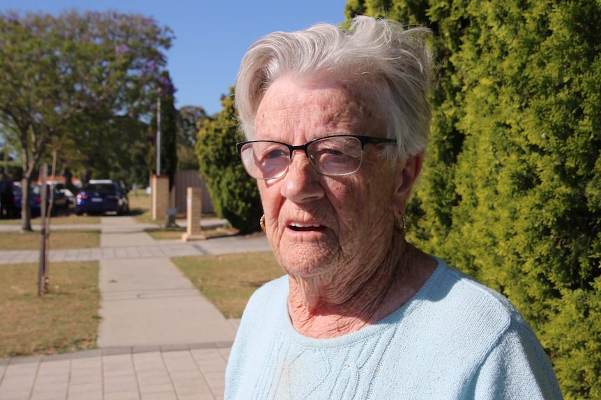 a woman who gave her name as Dee stands on a street in Perth's northern suburbs