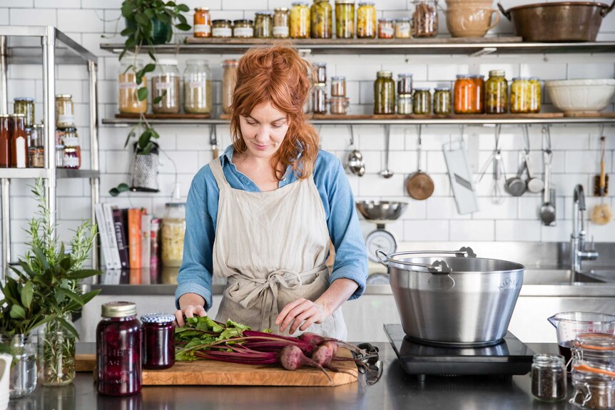 Alex Elliott-Howery with some beetroots in her kitchen