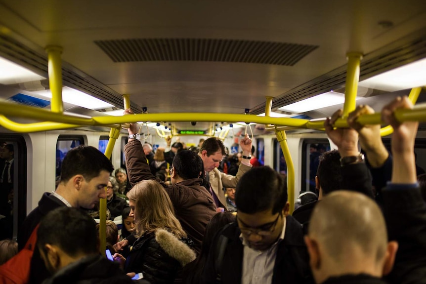 Commuters stand on a suburban train in Melbourne.