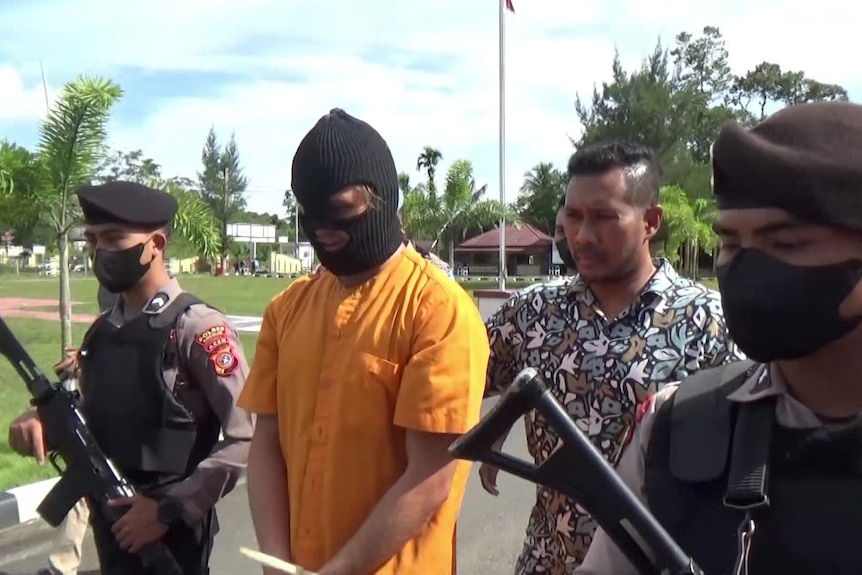 Bodhi Mani Risby-Jones paraded by Indonesian authorities in balaclava and jumpsuit