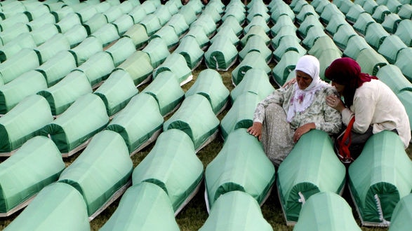 A Muslim women cries by the coffin of her relative.