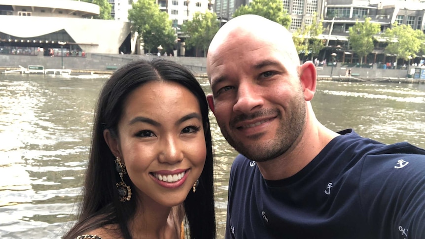 Lisa Du and Brad Donnini take a selfie in front of water