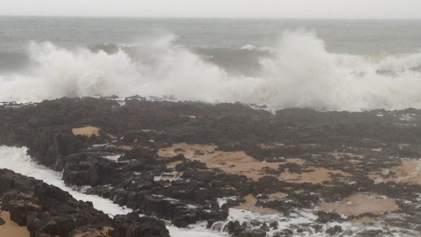 Waves smash on rocks at Bunbury as cold front crosses WA's South West coast