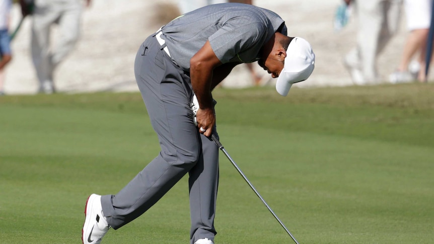 Testing day ... Tiger Woods reacts after hitting on the 11th fairway during the third round in the Bahamas