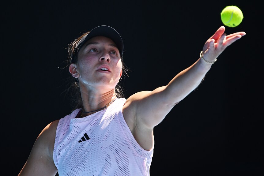 An American female tennis player prepares to serve at the Australian Open.