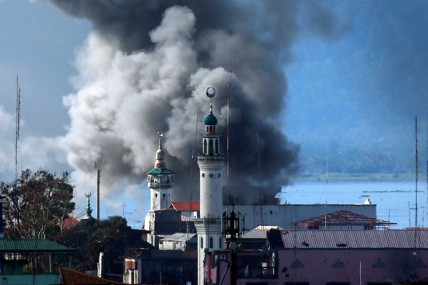 An explosion is seen after a Philippines army aircraft released a bomb during an airstrike.