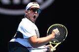 Dylan Alcott pumps his fist and screams during the men's quad wheelchair final at the Australian Open.