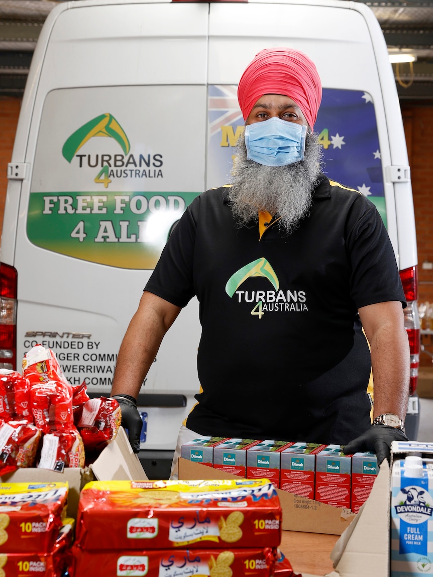 A man with a turban with some grocery items