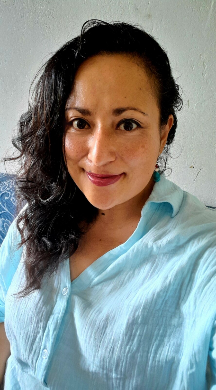 Selfie of Fijian woman smiling at camera. Wearing a blue shirt.