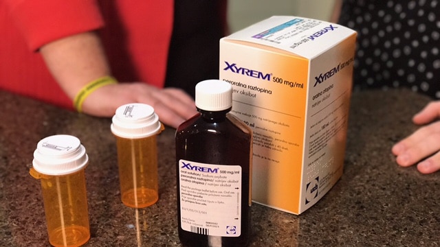 An orange box labelled Xyrem containing pills to treat narcolepsy sit on a kitchen bench