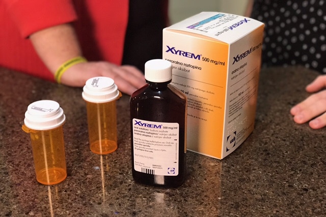 An orange box labelled Xyrem containing pills to treat narcolepsy sit on a kitchen bench