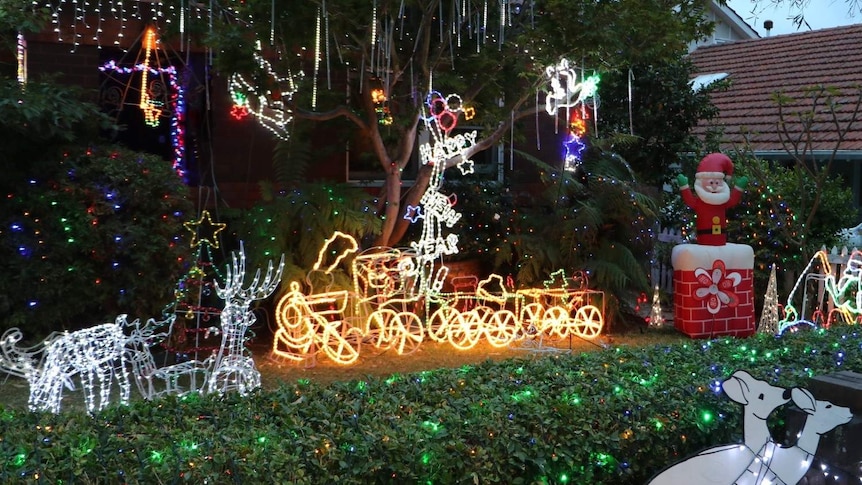 Photo of twinkly Christmas lights and inflatable Santa on show outside house in Sydney.