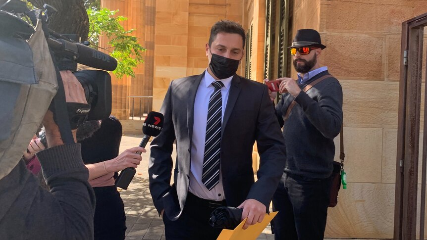 A man wearing a mask outside an Adelaide court.