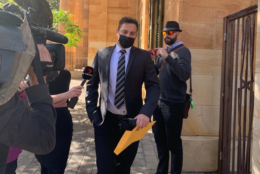 A man wearing a mask outside an Adelaide court.