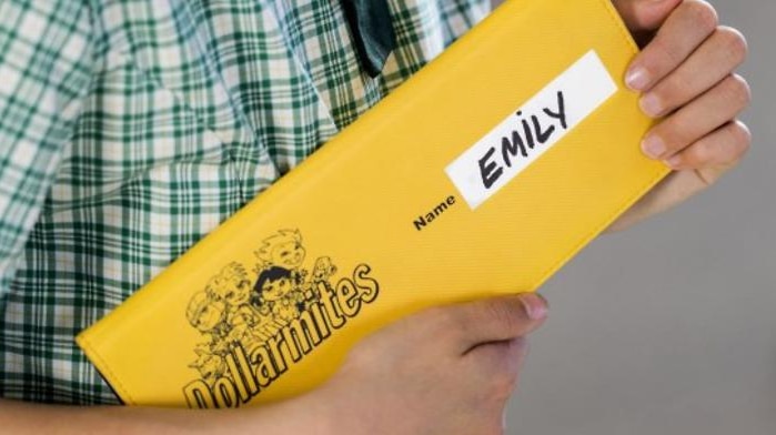 A student holds a dollarmite cheque book. 