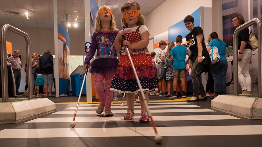 Emily and Olivia Webb experience what it is like to walk with a white cane.