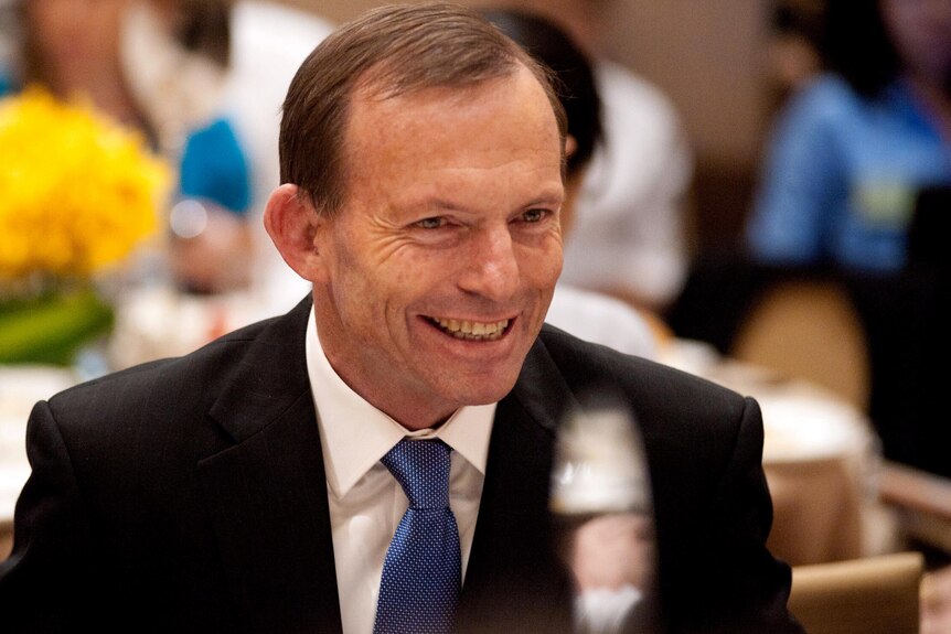 Tony Abbott chats with guests at a breakfast meeting in Beijing.