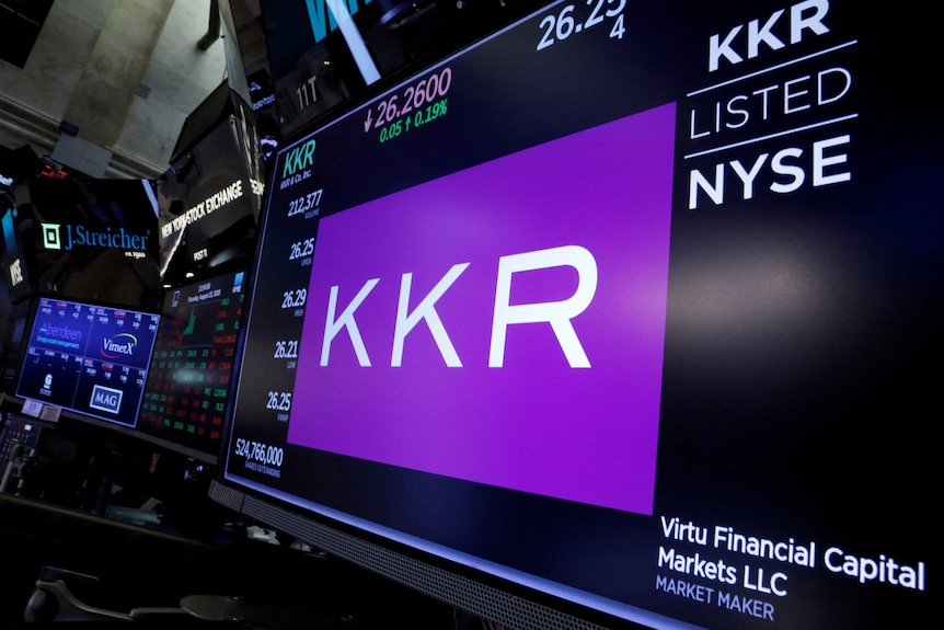 A large computer screen displays a purple logo for KKR with financial stats