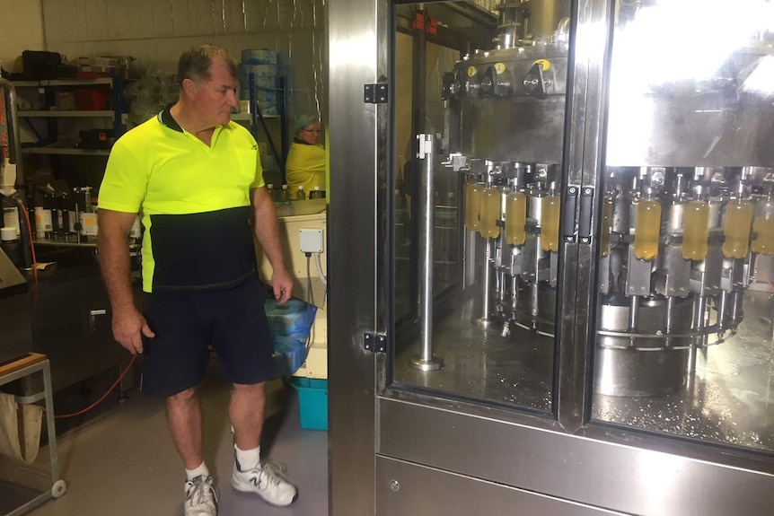 Man in high visibility shirt working in his brewery