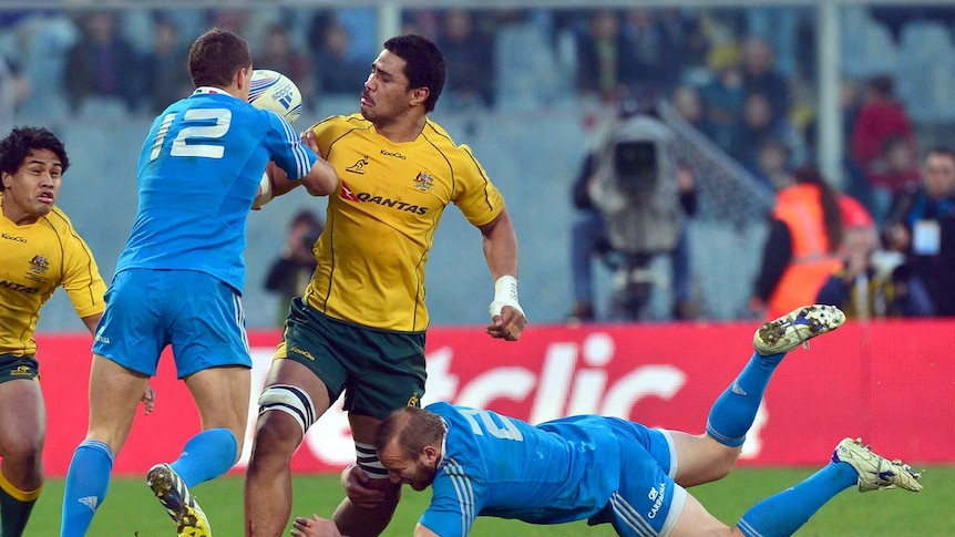 Wallabies lock Sitaleki Timani (C) is tackled in Australia's 22-19 win over Italy in Florence.