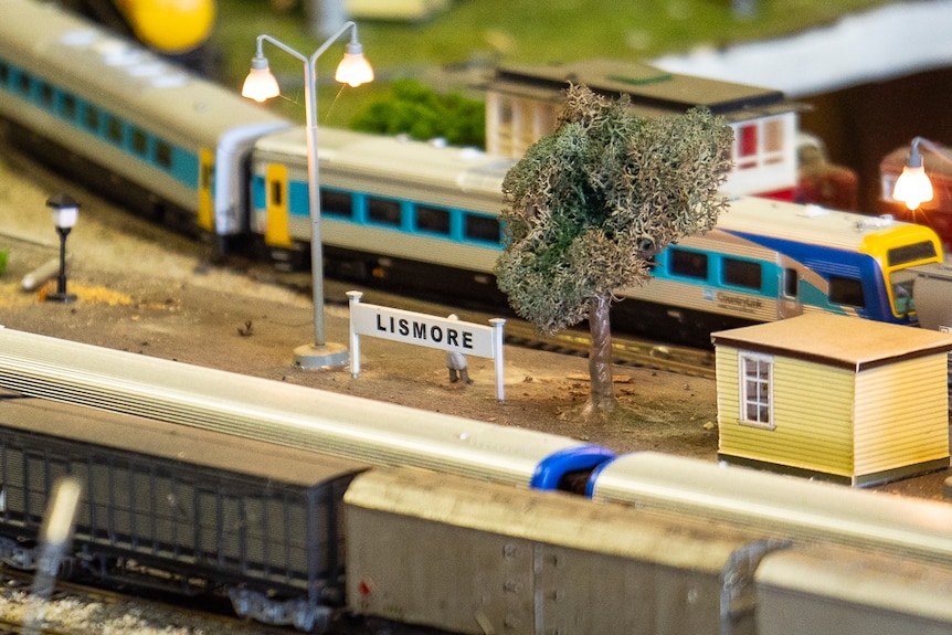 Close up of a miniature model railway train set with a rail stop sign of Lismore station.