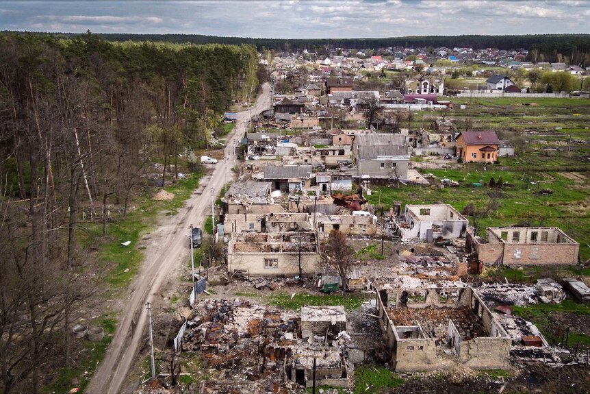 A drone shot of a small town, with all the houses blown apart or damaged