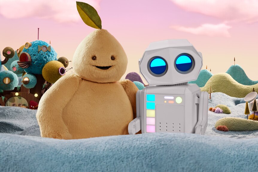 A yellow creature with a smiling face and a leaf on its head standing next to a robot with large round eyes