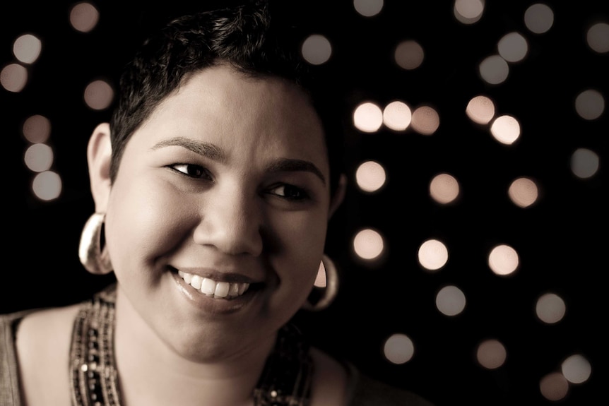 Sepia-toned photograph of Aboriginal and Torres Strait Islander musician Jessie Lloyd smiling.