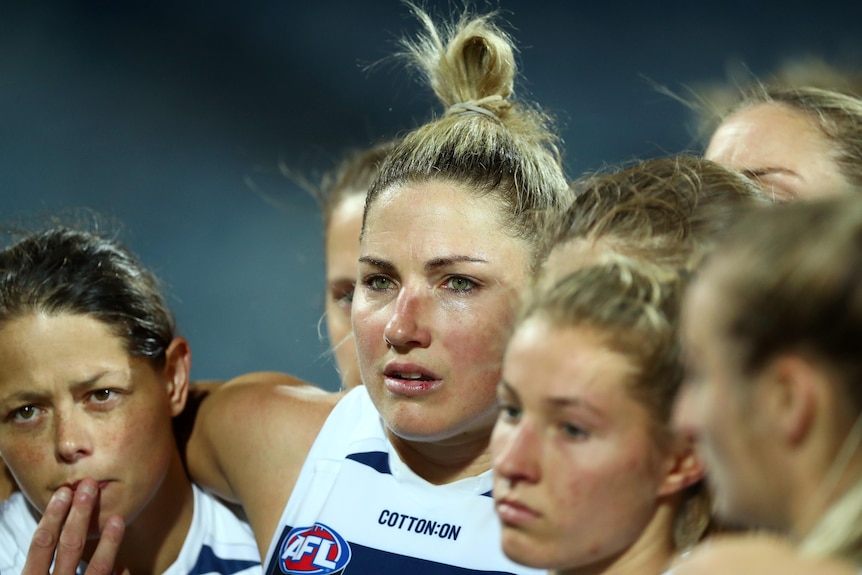 Melissa Hickey looks upset during a team huddle.