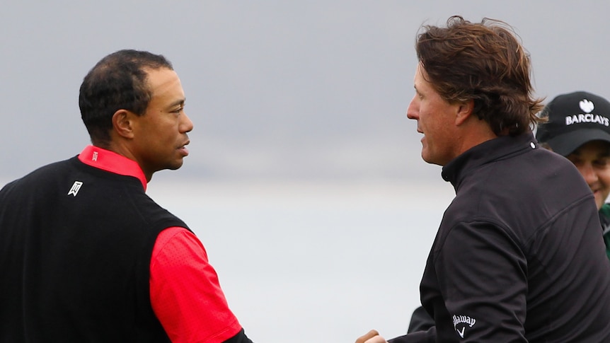 Old foes ... Tiger Woods shakes victorious playing partner Phil Mickelson's hand on the 18th.