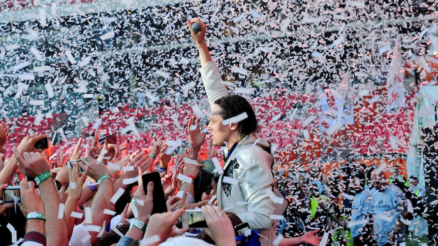 Win Butler of Arcade Fire in a flurry of confetti amongst the crowd at Big Day Out in 2014