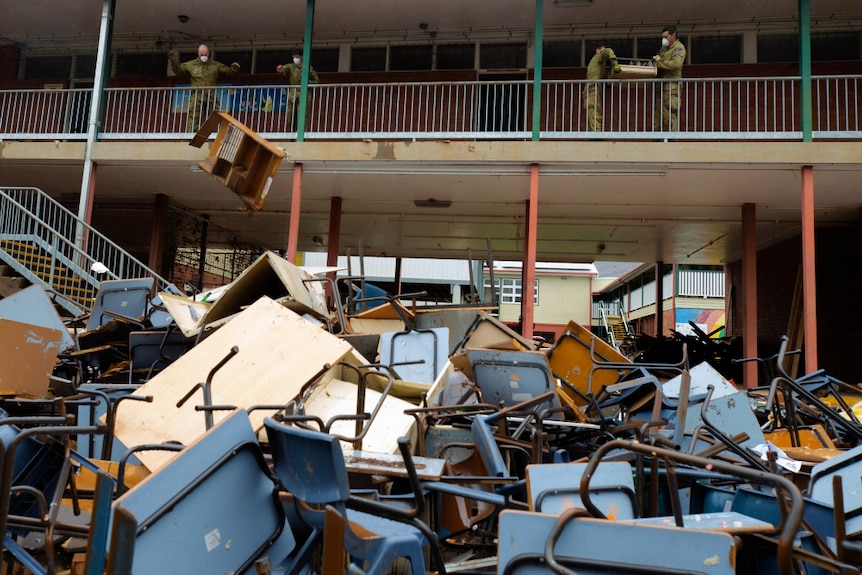Soldiers  remove flood-damaged equipment and furniture during a clean up of Richmond River High School in Lismore.